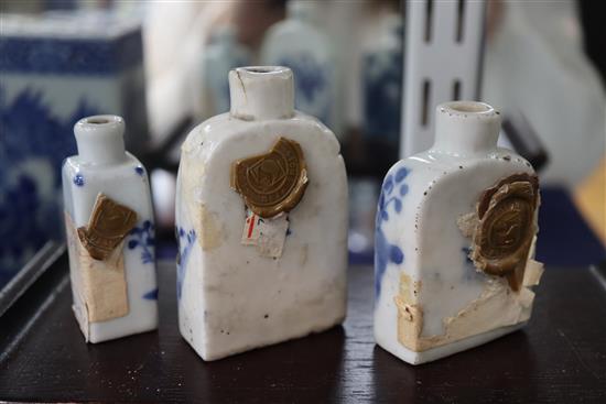 Two Chinese blue and white pillows and three similar snuff bottles, with three hardwood stands